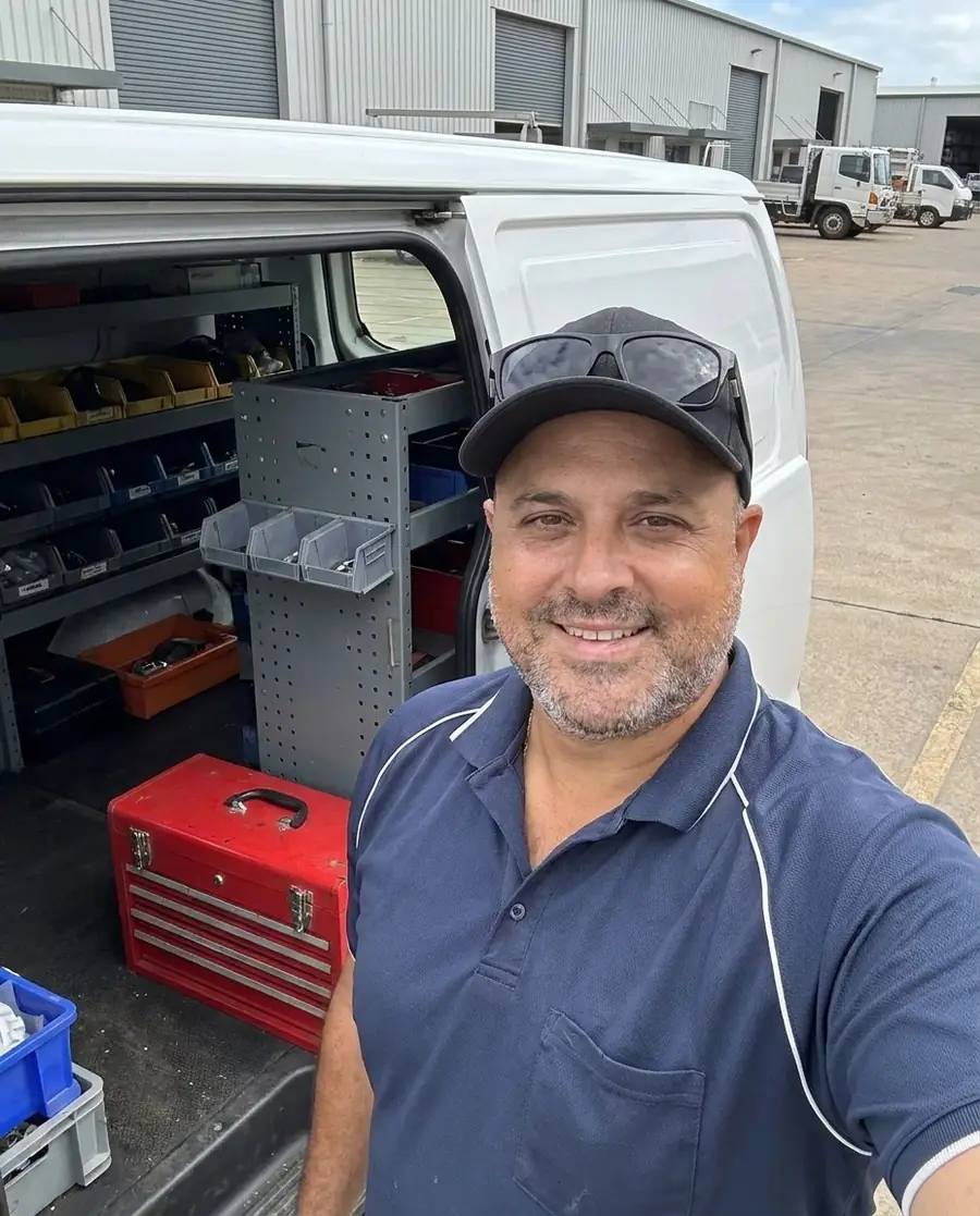 Sam Celesti beside his service van